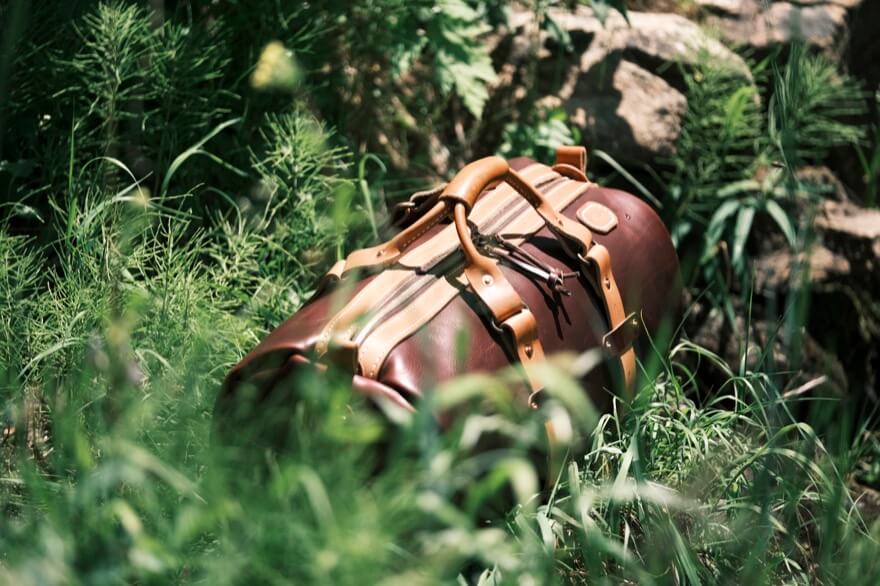 Leather bag sitting in a field